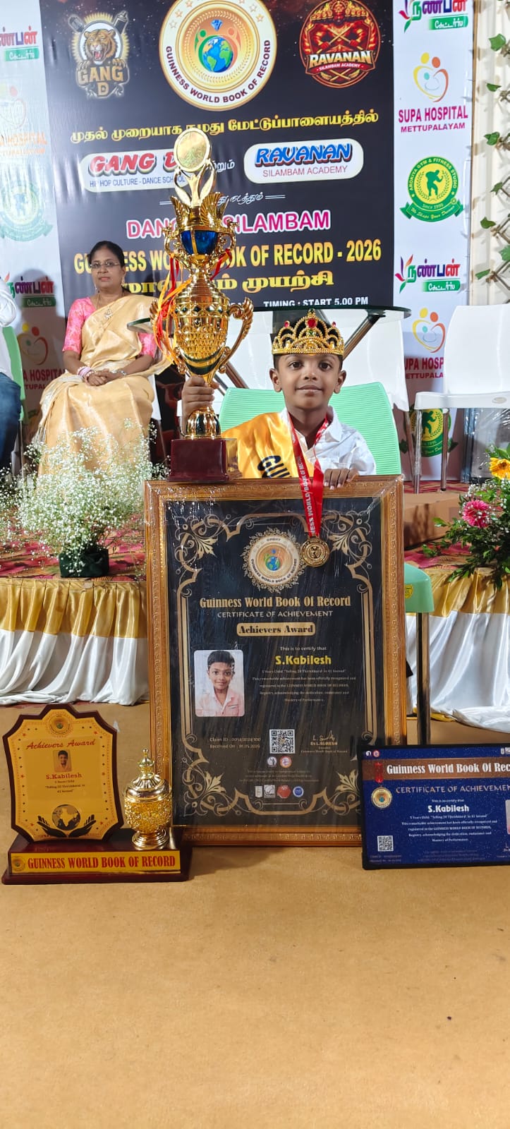 S. Kabilesh with his certificate and medal after reciting Thirukkural verses
